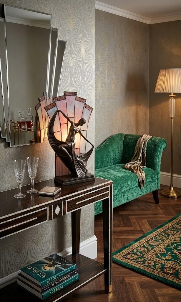 Lámpara Art Déco junto a una butaca de terciopelo verde